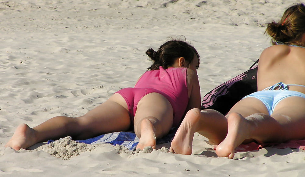 Spank her bottom at the beach