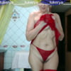 Lukerya in a red mesh dress, panties and stockings.